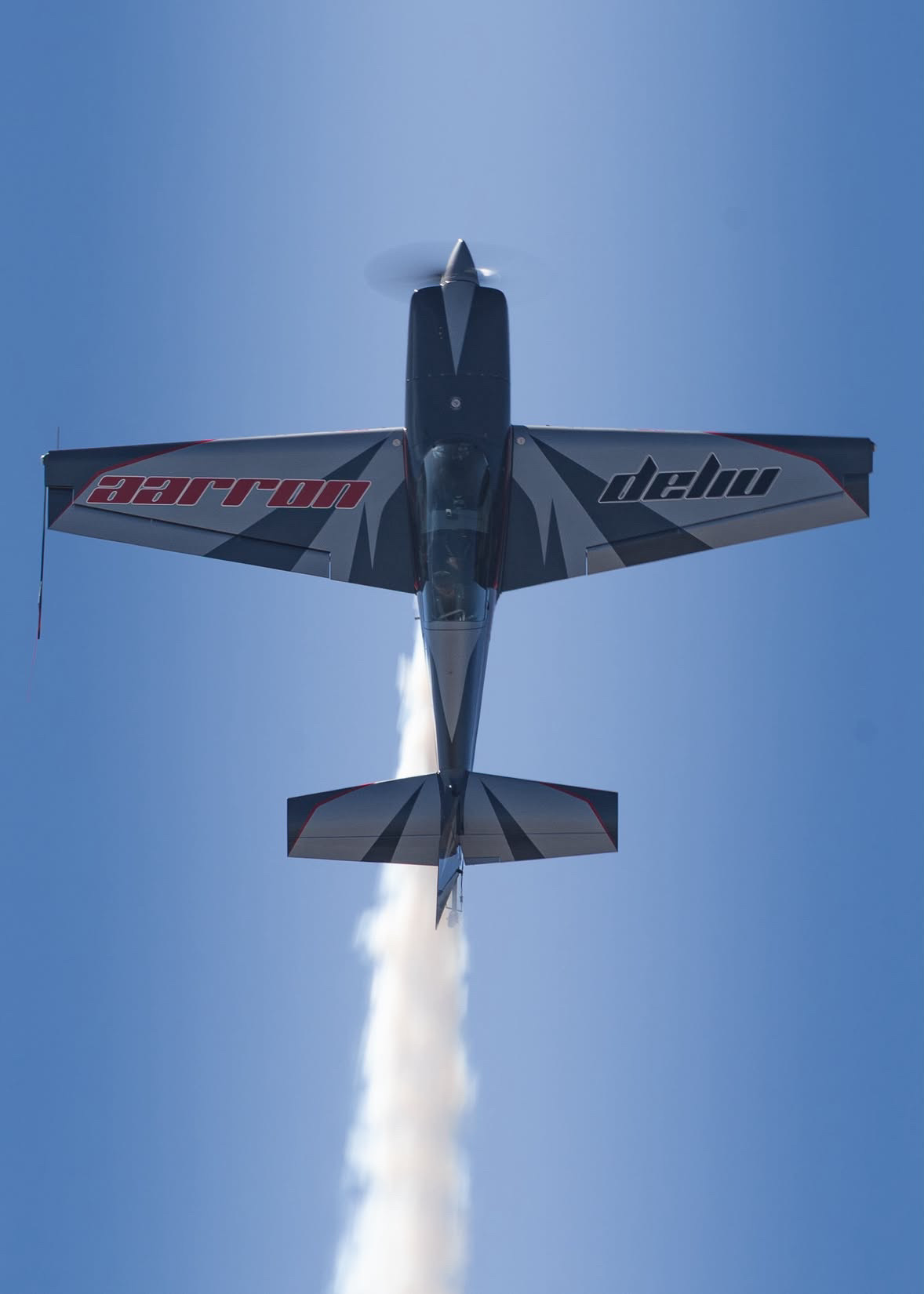 Looking straight up at Aarron's aircraft going vertical with the smoke on, his name across the underside of the wings.